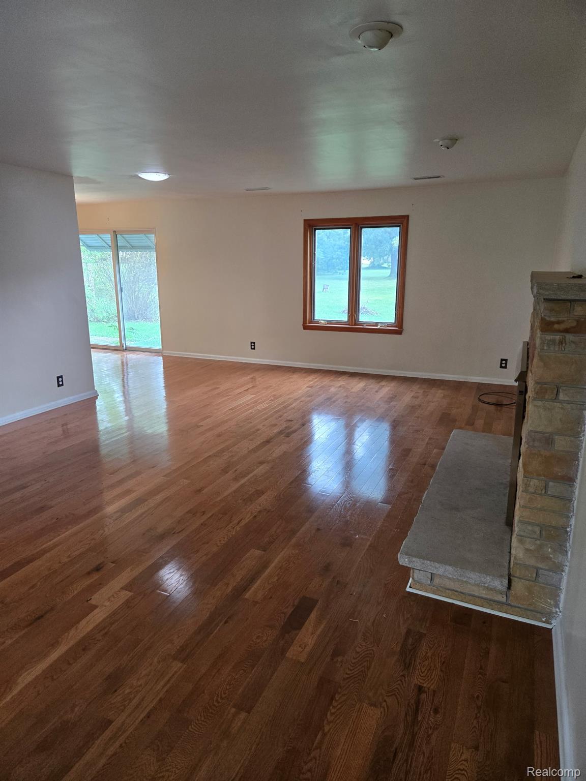 3176 East Fisher Road Bay City, MI 48706 - Photo 7 of 25 Spare room featuring dark wood-type flooring and baseboards