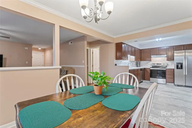 a view of a dining room with furniture and a chandelier