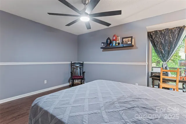 a bedroom with a large bed and a chandelier