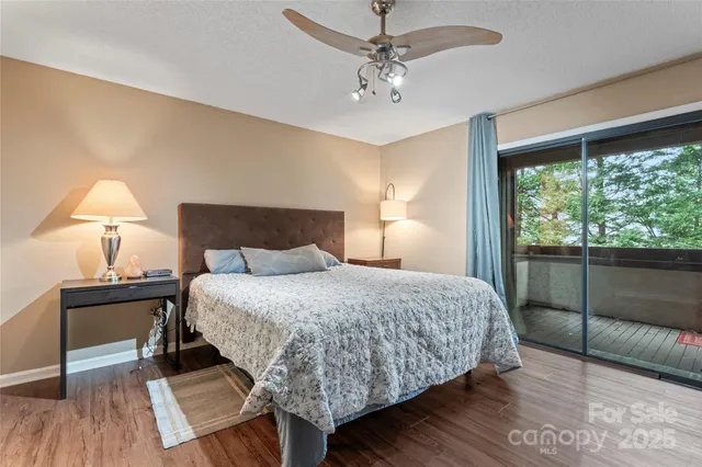 a bedroom with a bed wooden floor and window