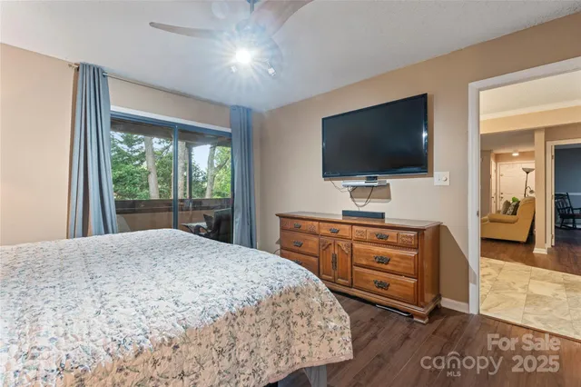 a bedroom with a large bed and a flat screen tv