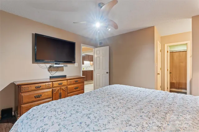 a bedroom with a bed and a flat screen tv