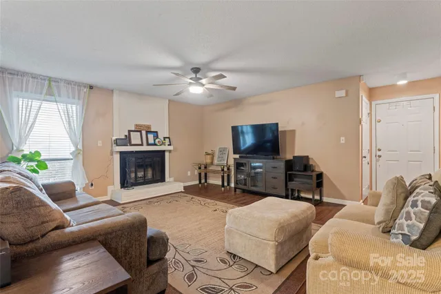 a living room with furniture a fireplace and a flat screen tv