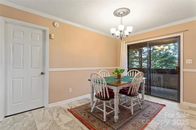 a dining room with furniture a chandelier and window