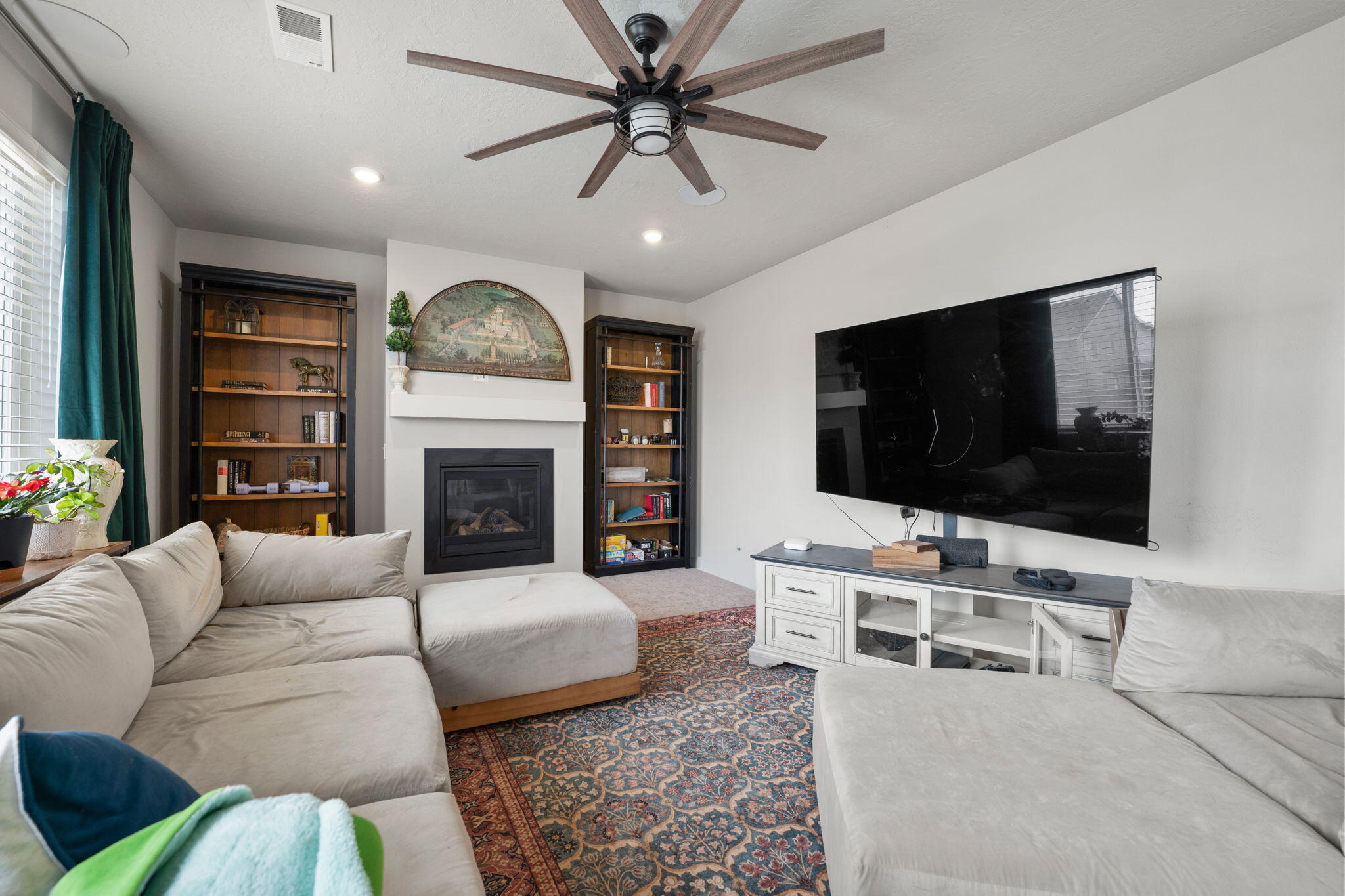 4039 Southwest Quartz Place Redmond, OR 97756 - Photo 18 of 44 a living room with furniture a flat screen tv and a fireplace