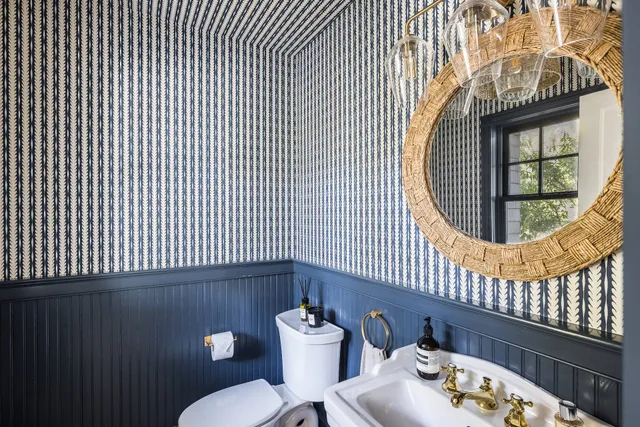 a bathroom with a sink a mirror and a toilet