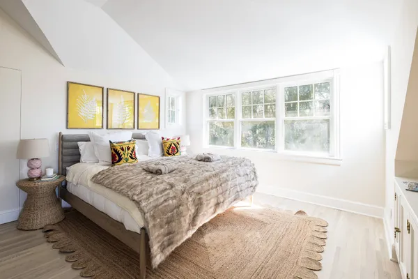 a bed sitting in a bedroom next to a window