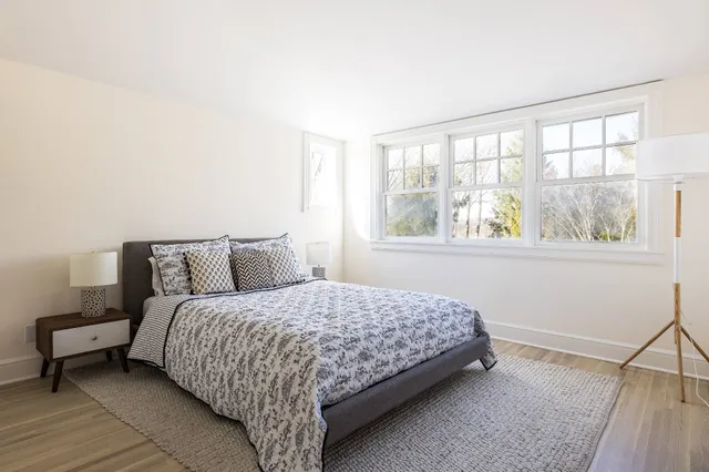 a bedroom with a bed and window