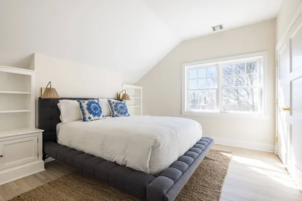 a bedroom with a large bed and a window