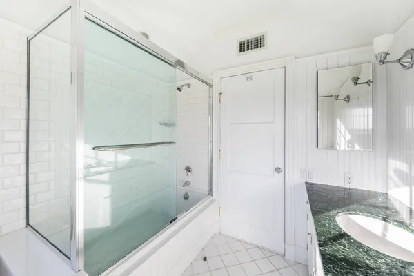 a bathroom with a shower and a sink
