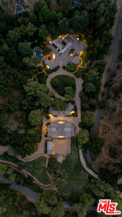 3099 Mandeville Canyon Road Los Angeles, CA 90049 - Photo 2 of 59 an aerial view of residential house with outdoor space and trees all around