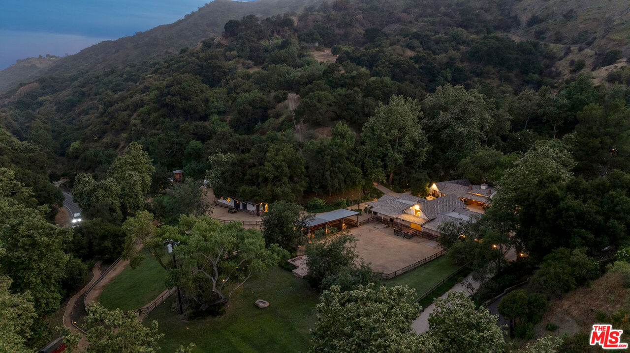 3099 Mandeville Canyon Road Los Angeles, CA 90049 - Photo 3 of 59 an aerial view of residential house with outdoor space and trees all around
