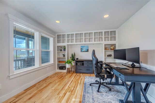 a view of a workspace with furniture and a window