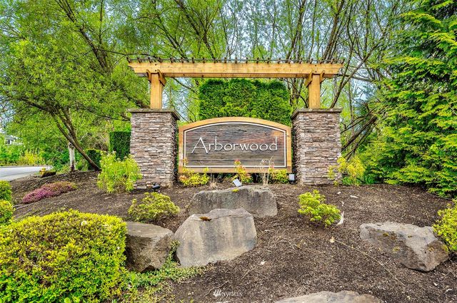 a sign board with a yard