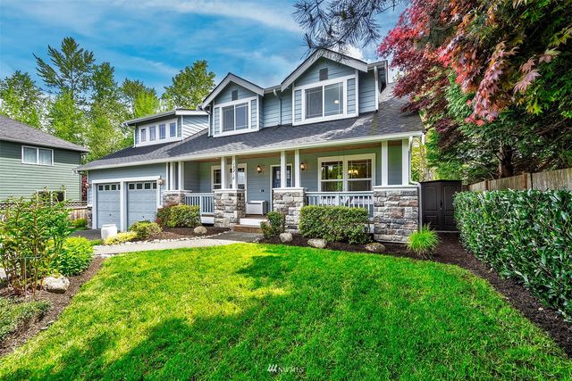 a front view of a house with a yard patio and green space