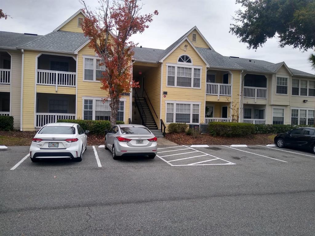1075 South Hiawassee Road, Unit 911 Orlando, FL 32835 - Photo 1 of 1 a car parked in front of a white house