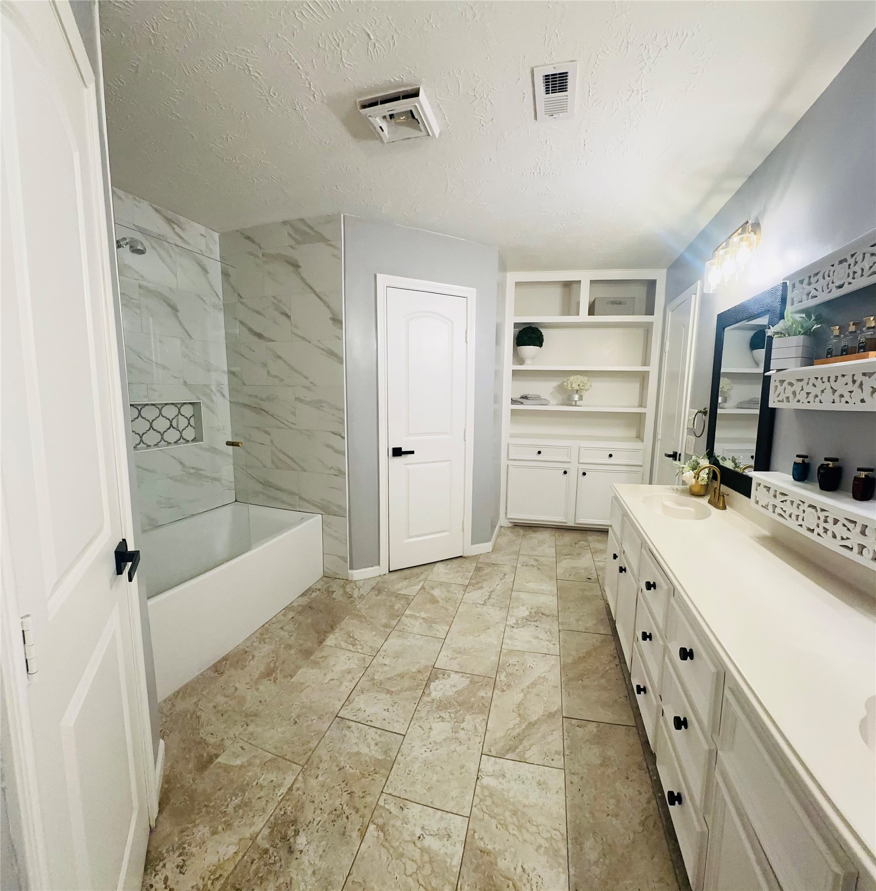 1457 Camellia Street Sweeny, TX 77480 - Photo 14 of 26 a spacious bathroom with a granite countertop sink a mirror and a bathtub