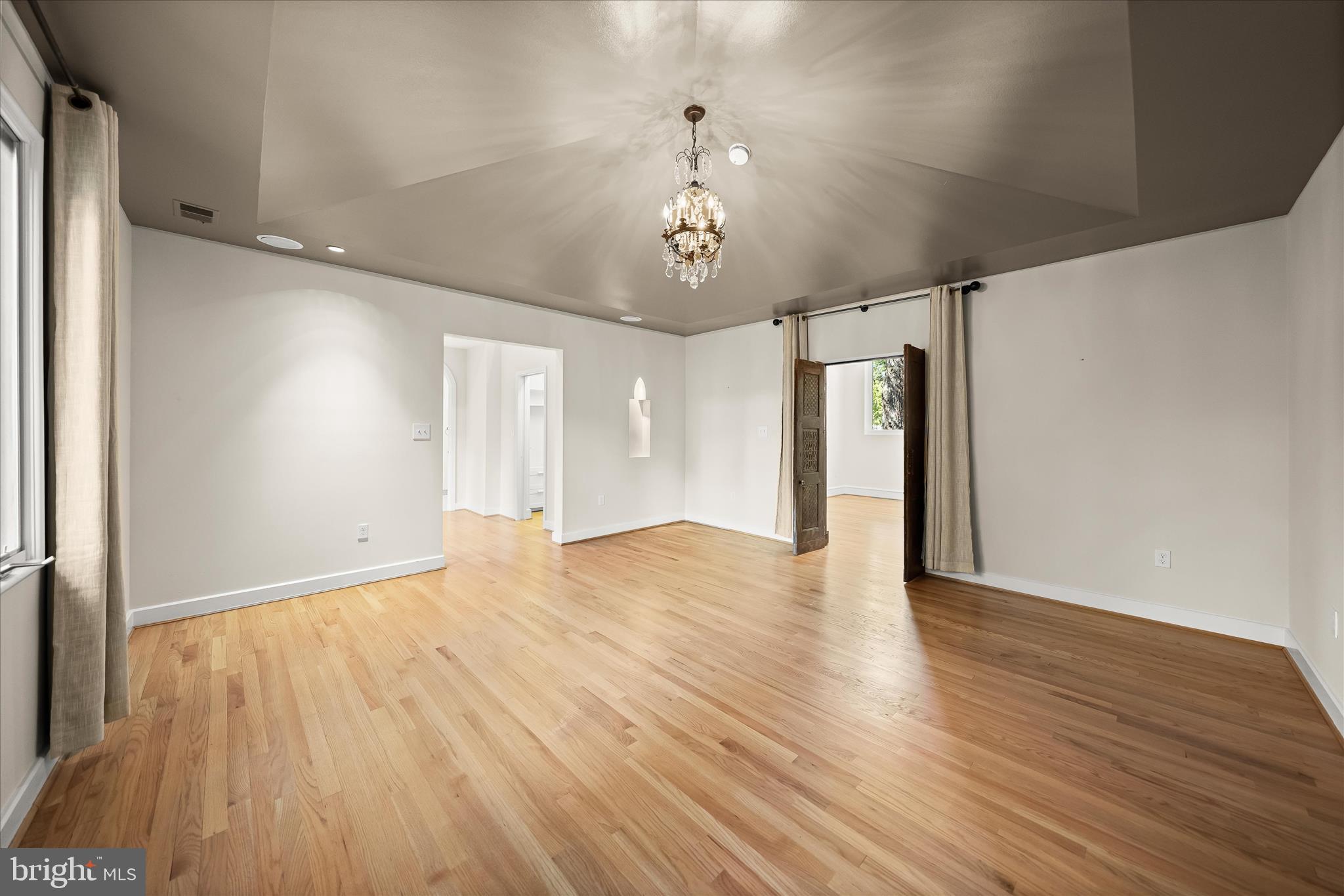 5104 Scarsdale Road Bethesda, MD 20816 - Photo 35 of 68 a view of an empty room with wooden floor and windows