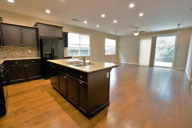 a kitchen with granite countertop a stove and cabinets