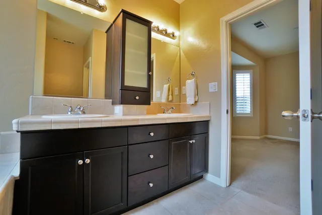 a bathroom with a sink a toilet and a mirror