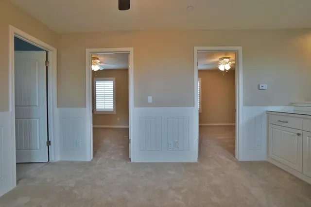 an empty room with windows and closet