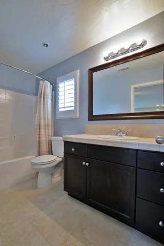 a view of a house with a wooden fence