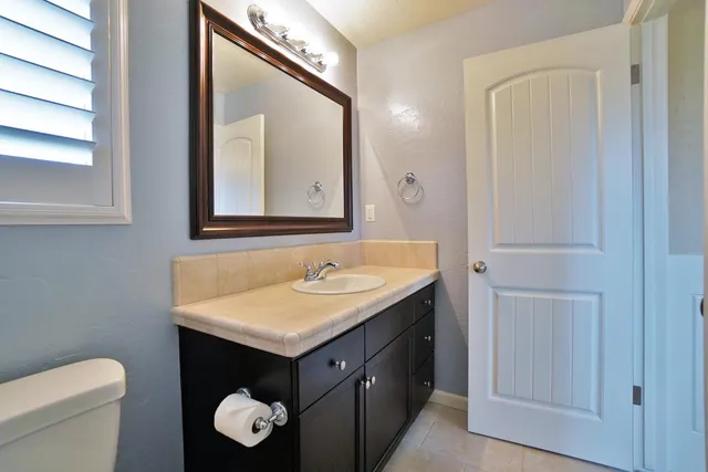 a front view of a house with plants