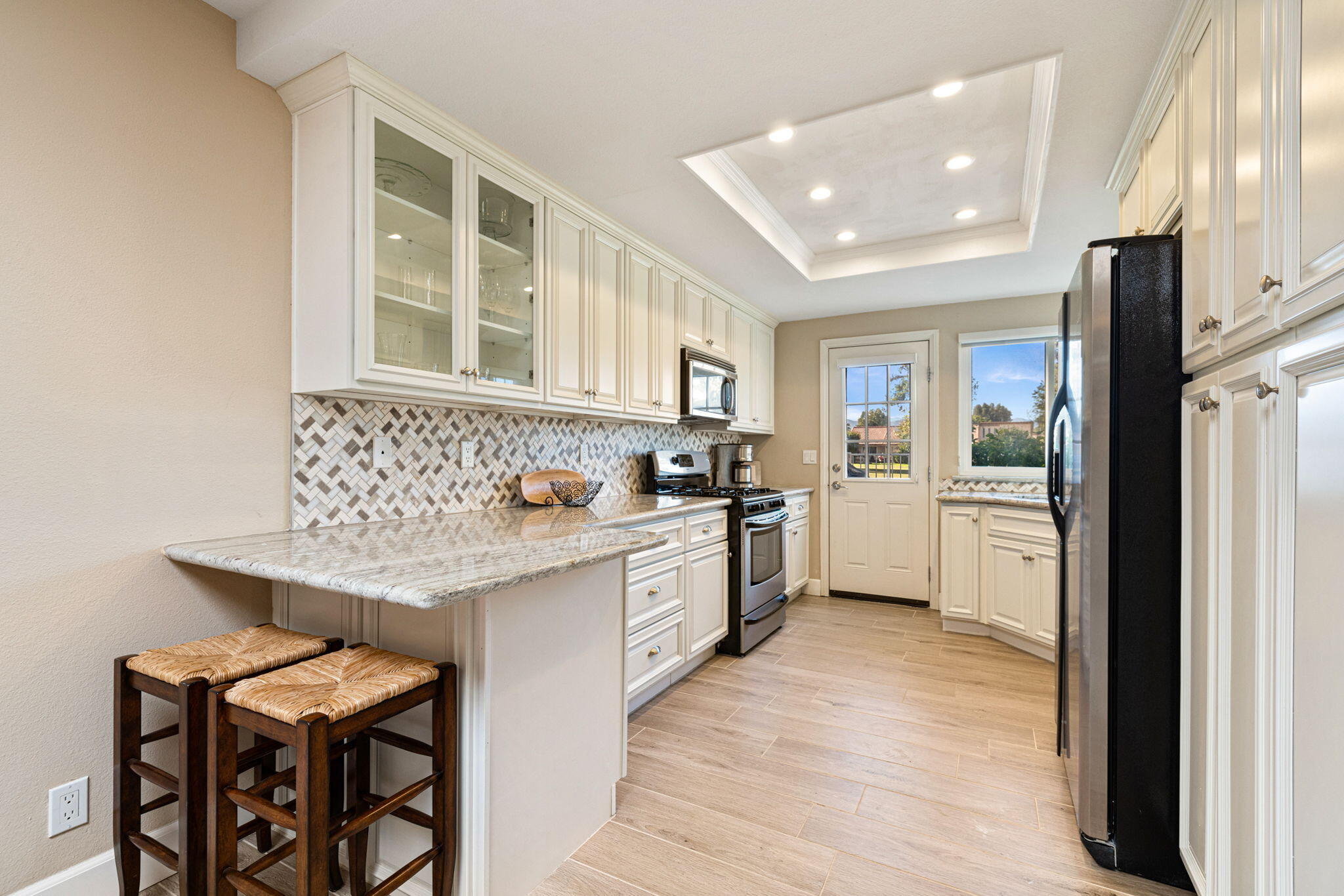 49091 Taylor Street Indio, CA 92201 - Photo 1 of 49 a large kitchen with granite countertop lots of counter top space and refrigerator