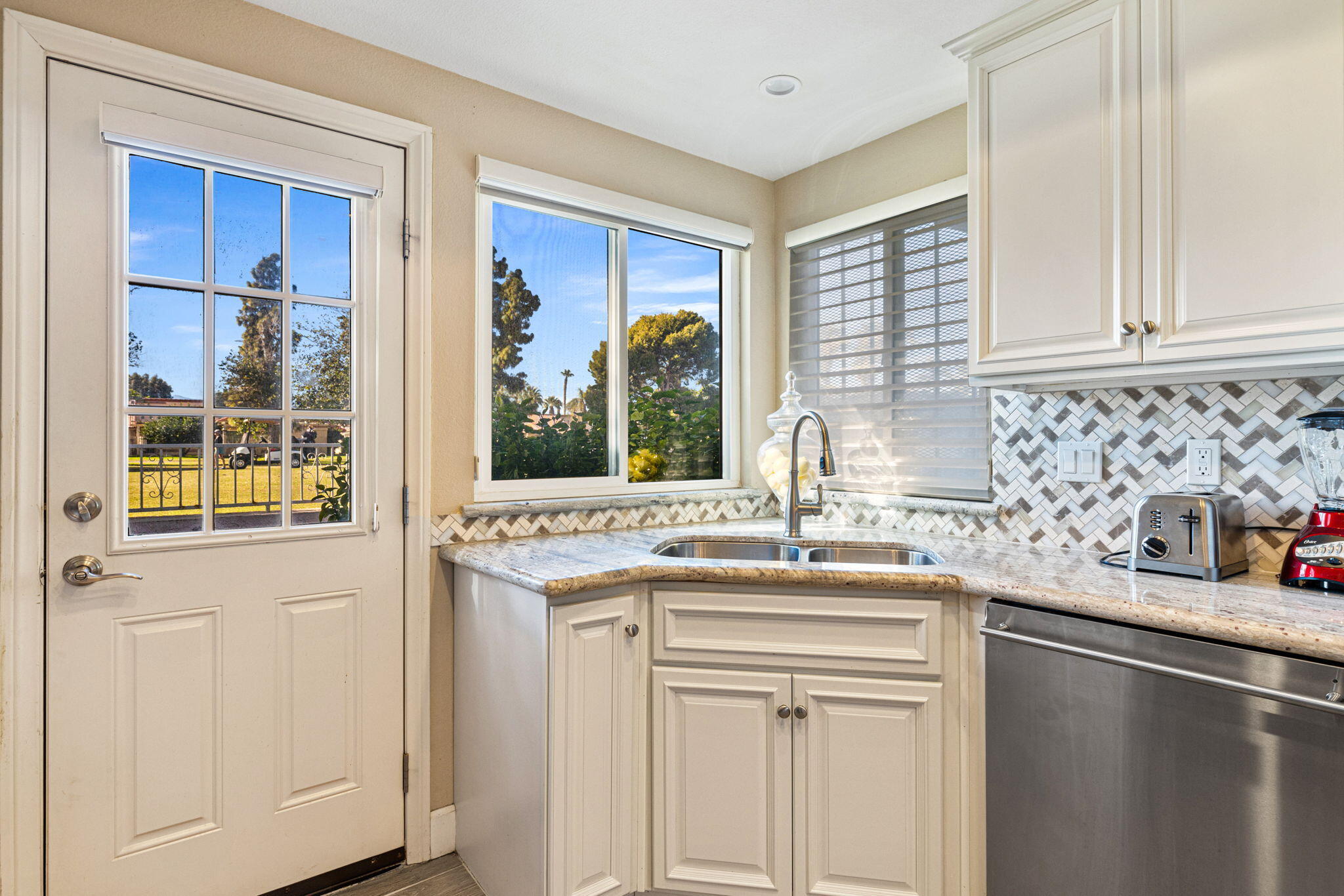 49091 Taylor Street Indio, CA 92201 - Photo 16 of 49 a kitchen with stainless steel appliances granite countertop a sink and a window