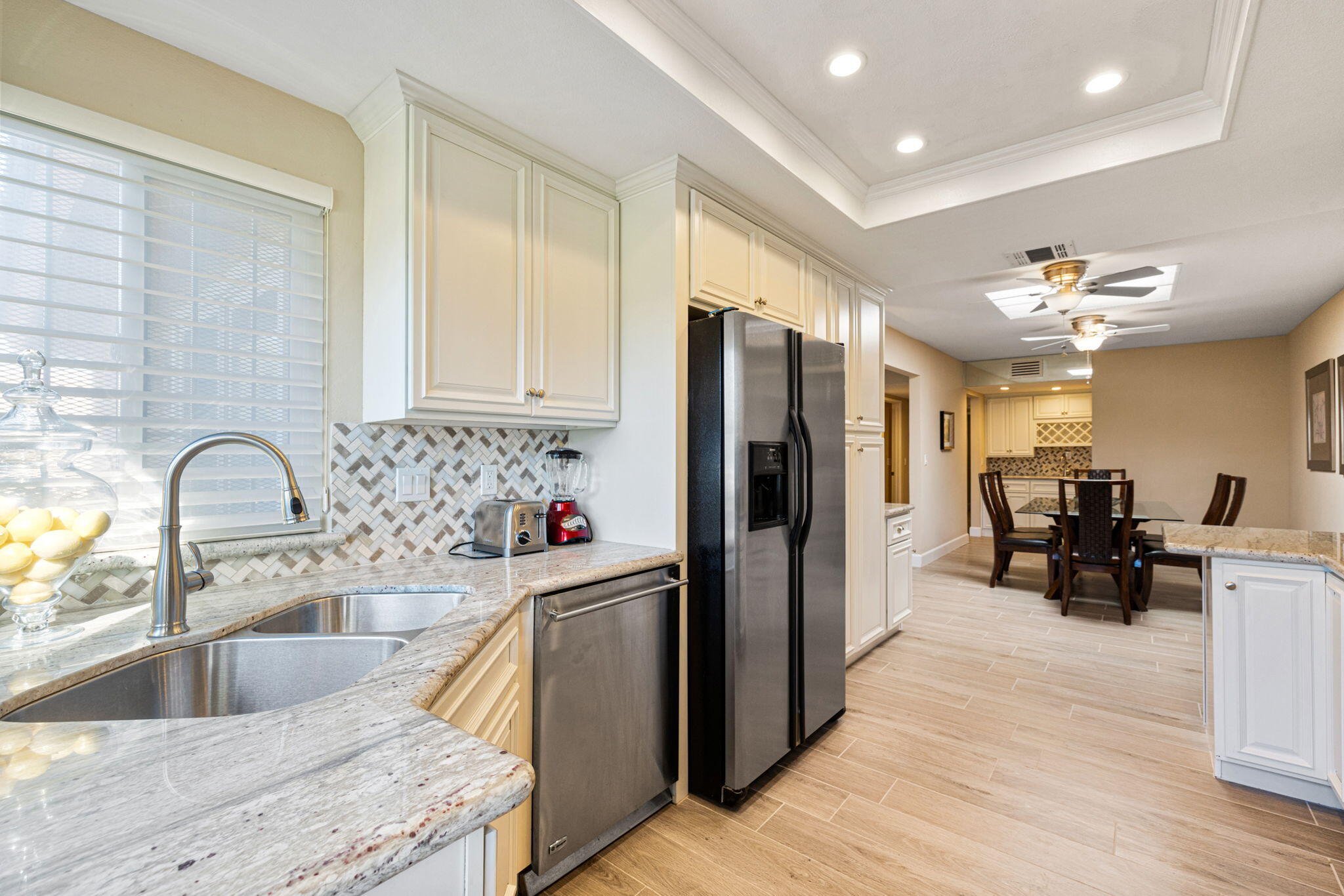 49091 Taylor Street Indio, CA 92201 - Photo 17 of 49 a kitchen with stainless steel appliances granite countertop a refrigerator and a sink
