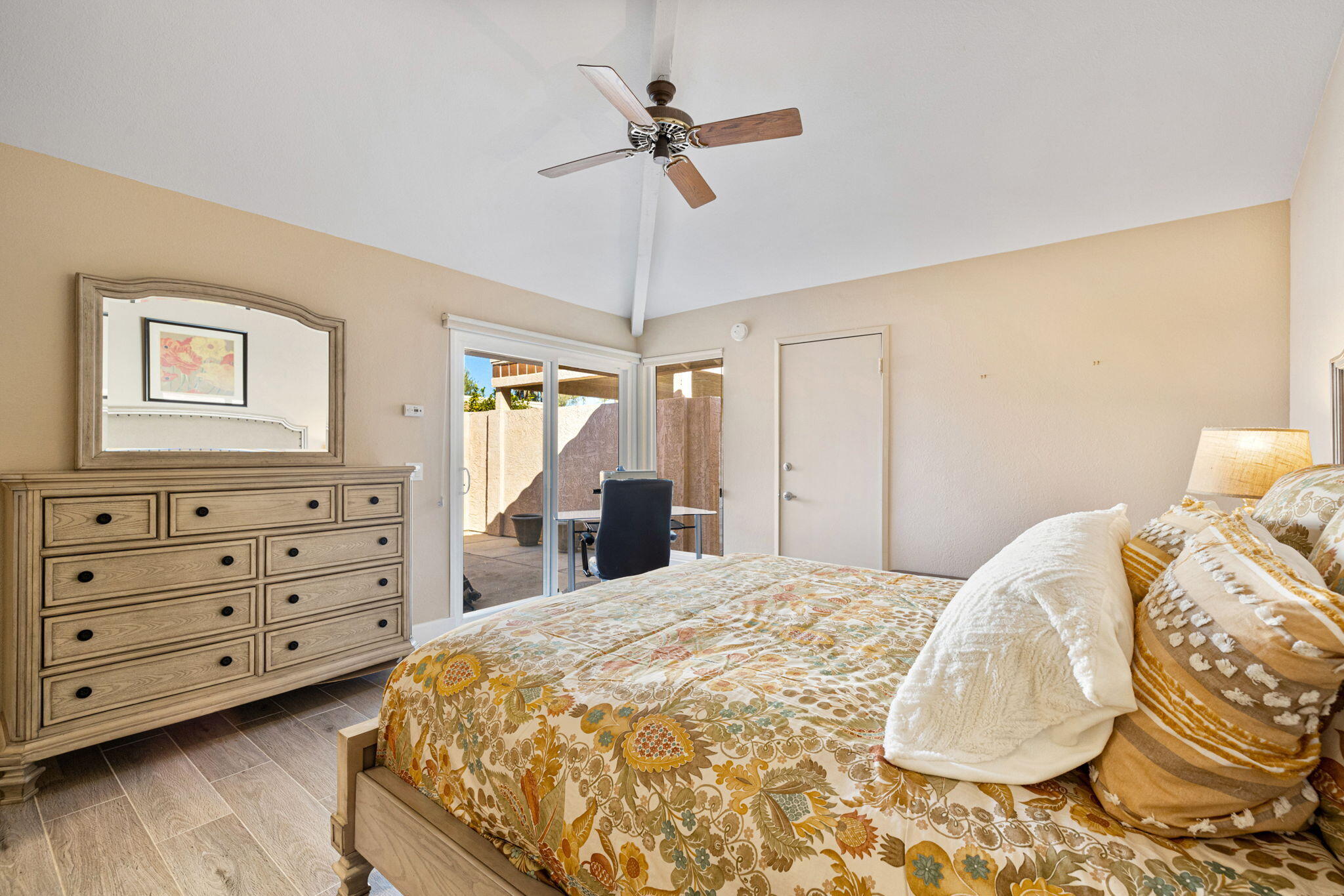 49091 Taylor Street Indio, CA 92201 - Photo 26 of 49 a bedroom with a bed and a chandelier