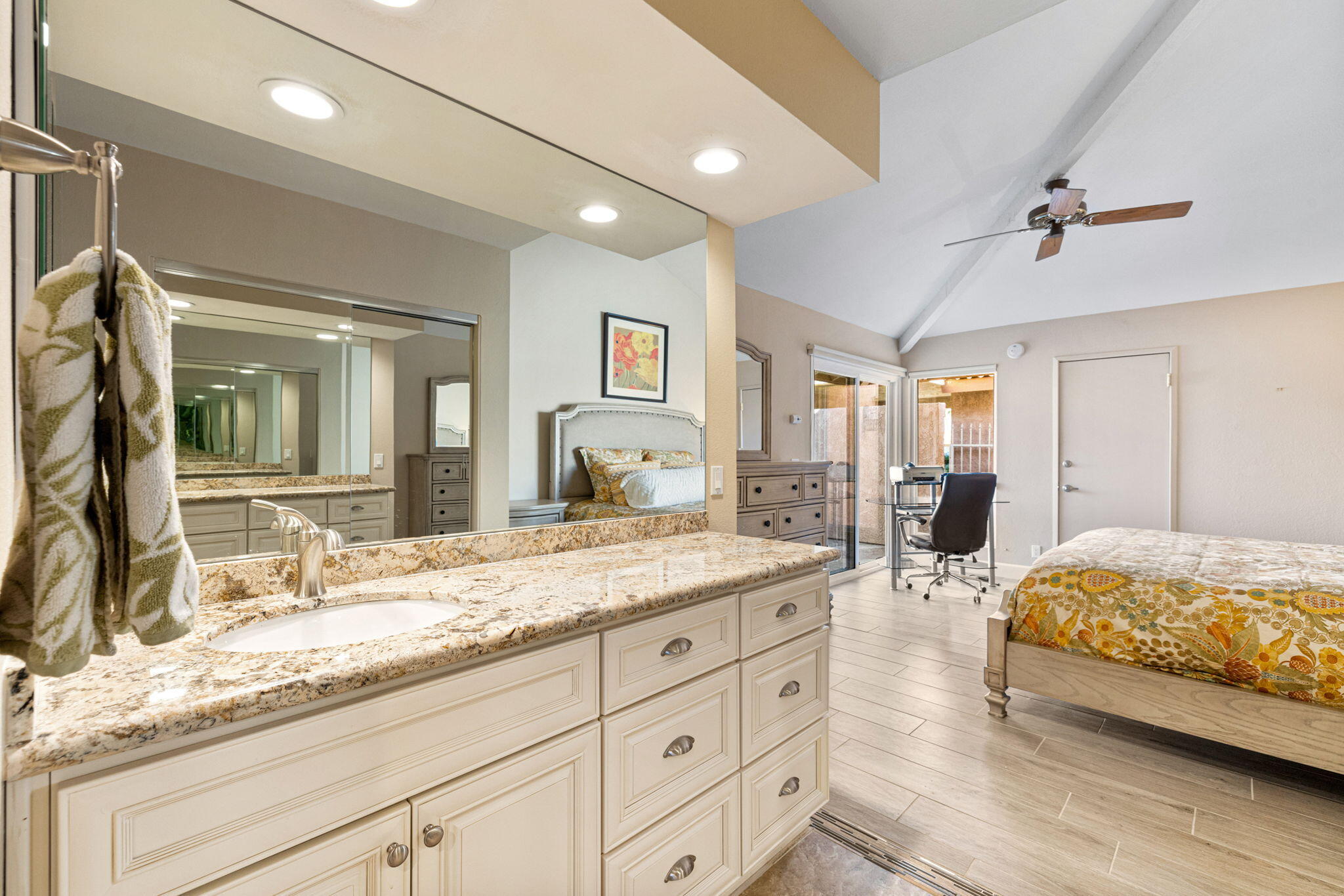49091 Taylor Street Indio, CA 92201 - Photo 27 of 49 a spacious bedroom with a granite countertop sink and a mirror