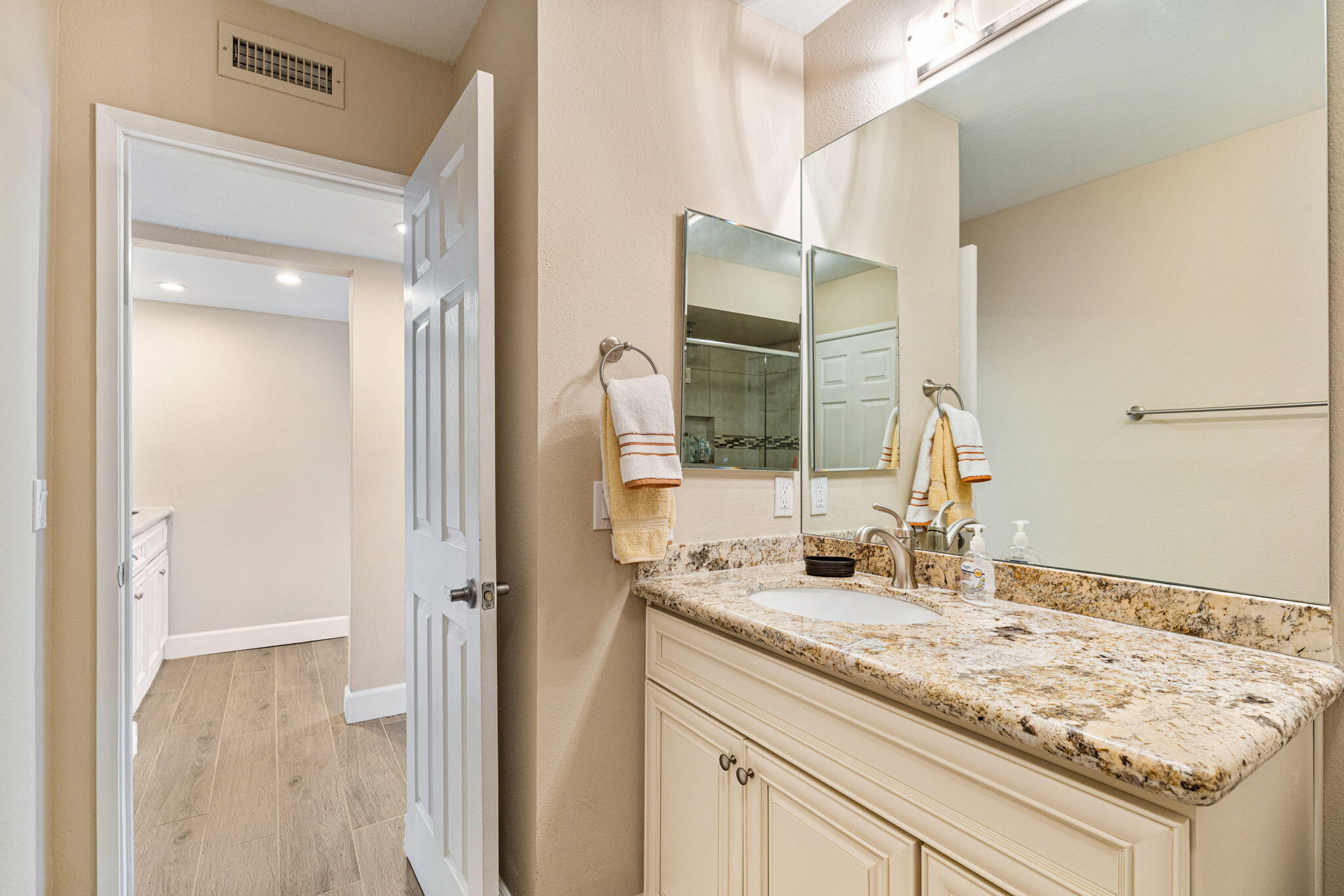 49091 Taylor Street Indio, CA 92201 - Photo 30 of 49 a bathroom with a granite countertop sink and a mirror