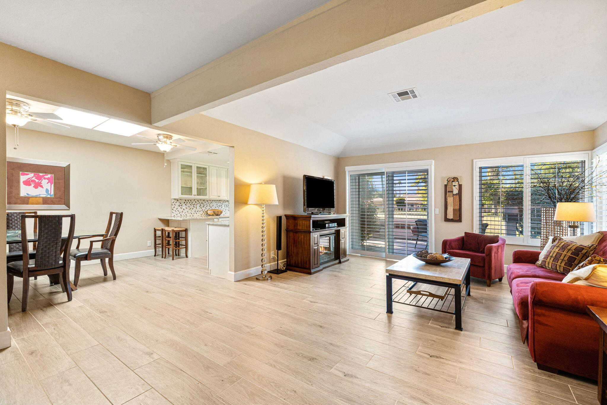 49091 Taylor Street Indio, CA 92201 - Photo 5 of 49 a living room with furniture and a flat screen tv with kitchen view
