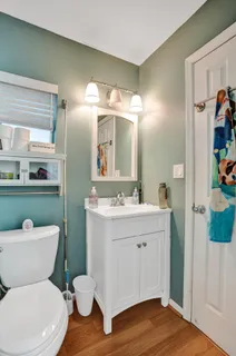 a white toilet sitting next to a bathroom sink