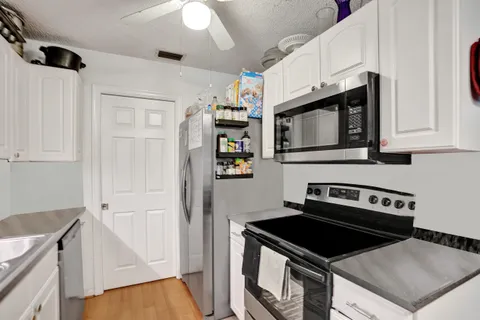 a kitchen with stainless steel appliances granite countertop a stove a microwave and a refrigerator