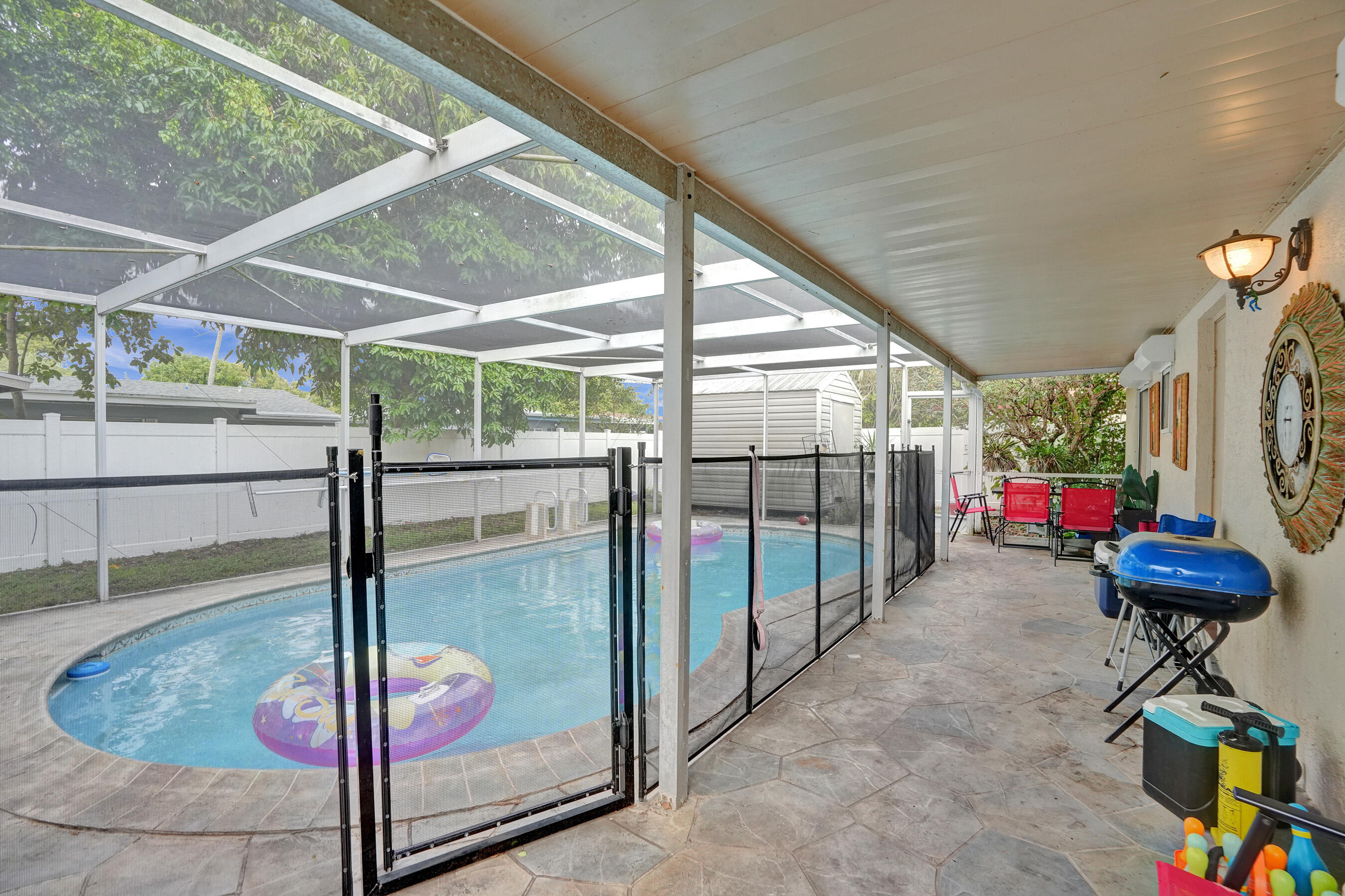 7697 Forest Boulevard North Lauderdale, FL 33068 - Photo 14 of 30 a living room with a floor to ceiling window and potted plant