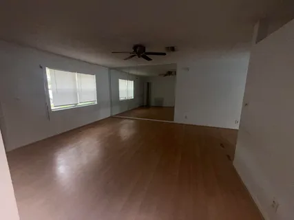 a view of a livingroom with a ceiling fan and window