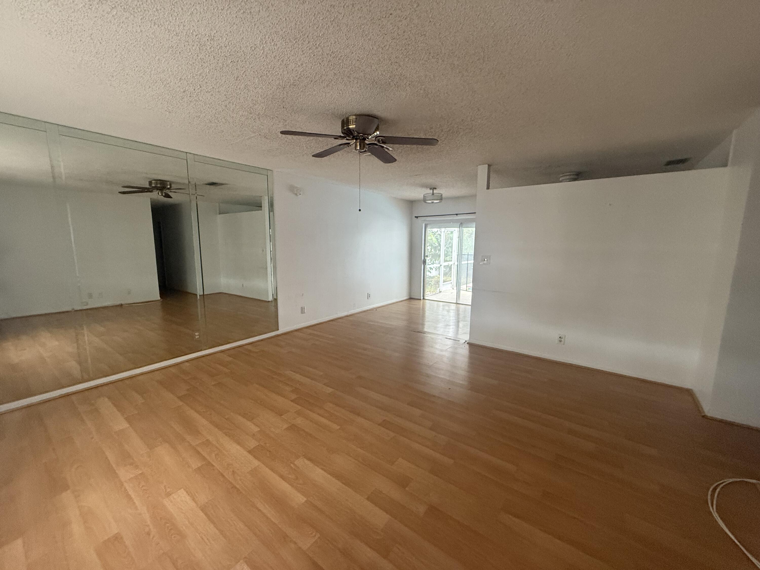 7697 Forest Boulevard North Lauderdale, FL 33068 - Photo 27 of 30 an empty room with wooden floor and windows