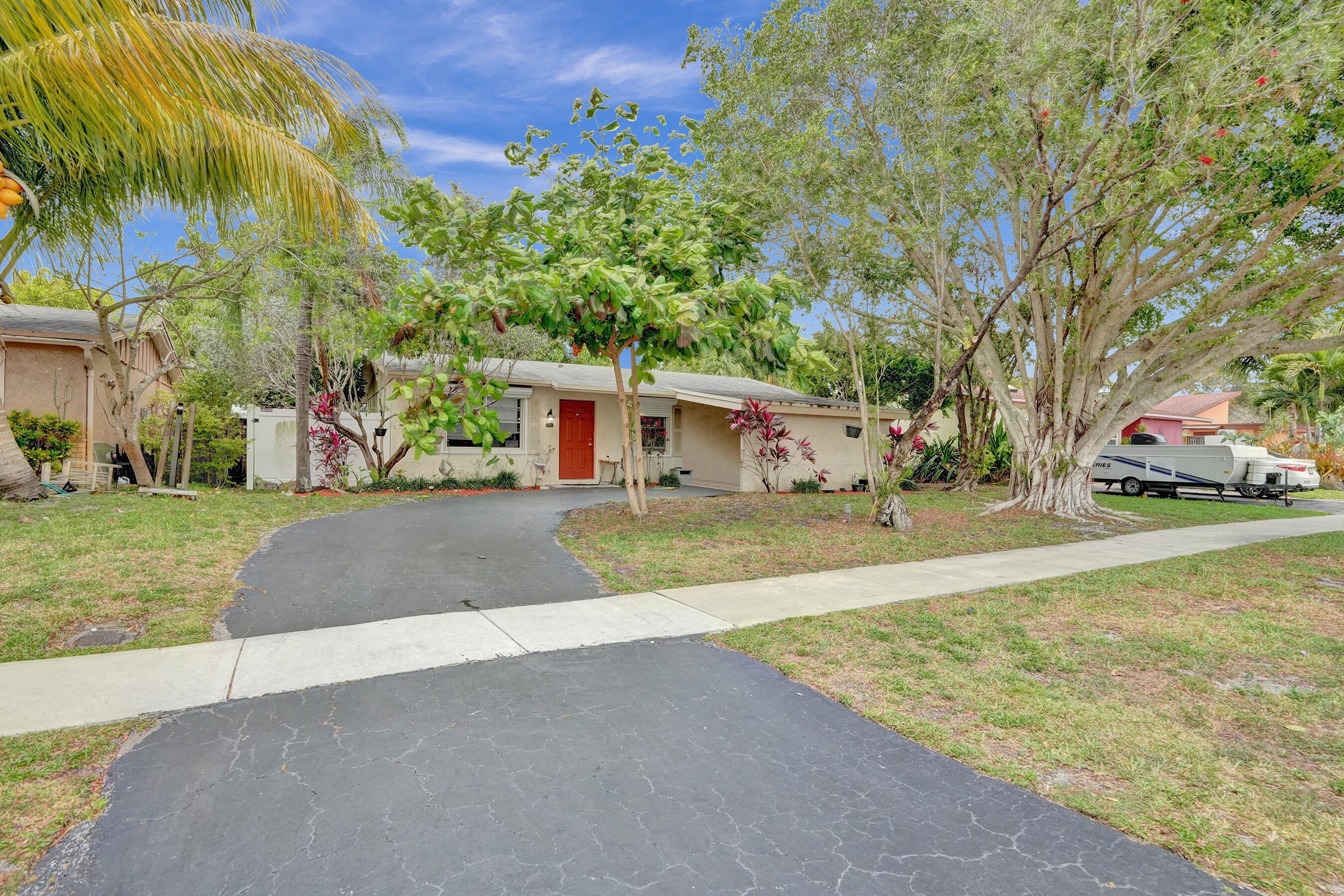 7697 Forest Boulevard North Lauderdale, FL 33068 - Photo 3 of 30 a front view of a house with a yard and garage
