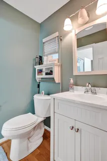 a bathroom with a sink a toilet and a mirror