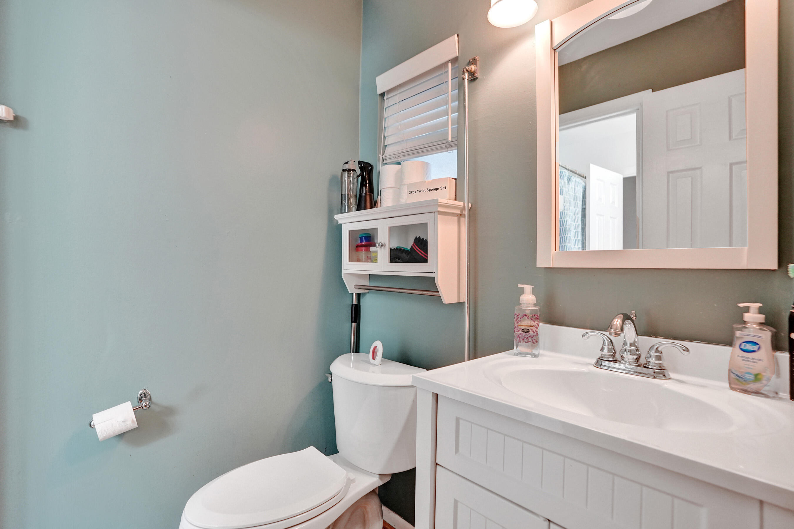 7697 Forest Boulevard North Lauderdale, FL 33068 - Photo 7 of 30 a bathroom with a sink a toilet and mirror