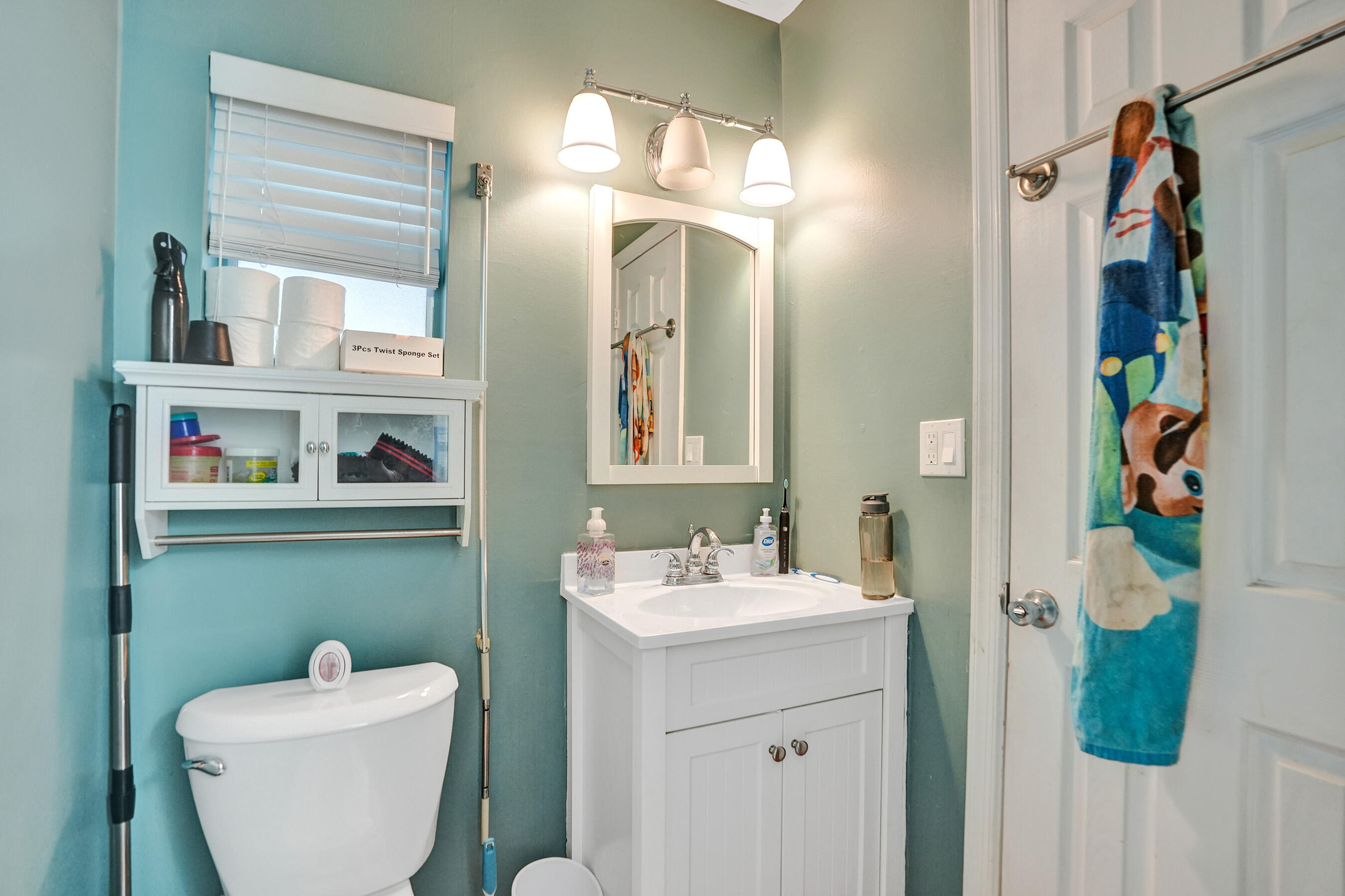 7697 Forest Boulevard North Lauderdale, FL 33068 - Photo 10 of 30 a bathroom with a toilet sink and mirror
