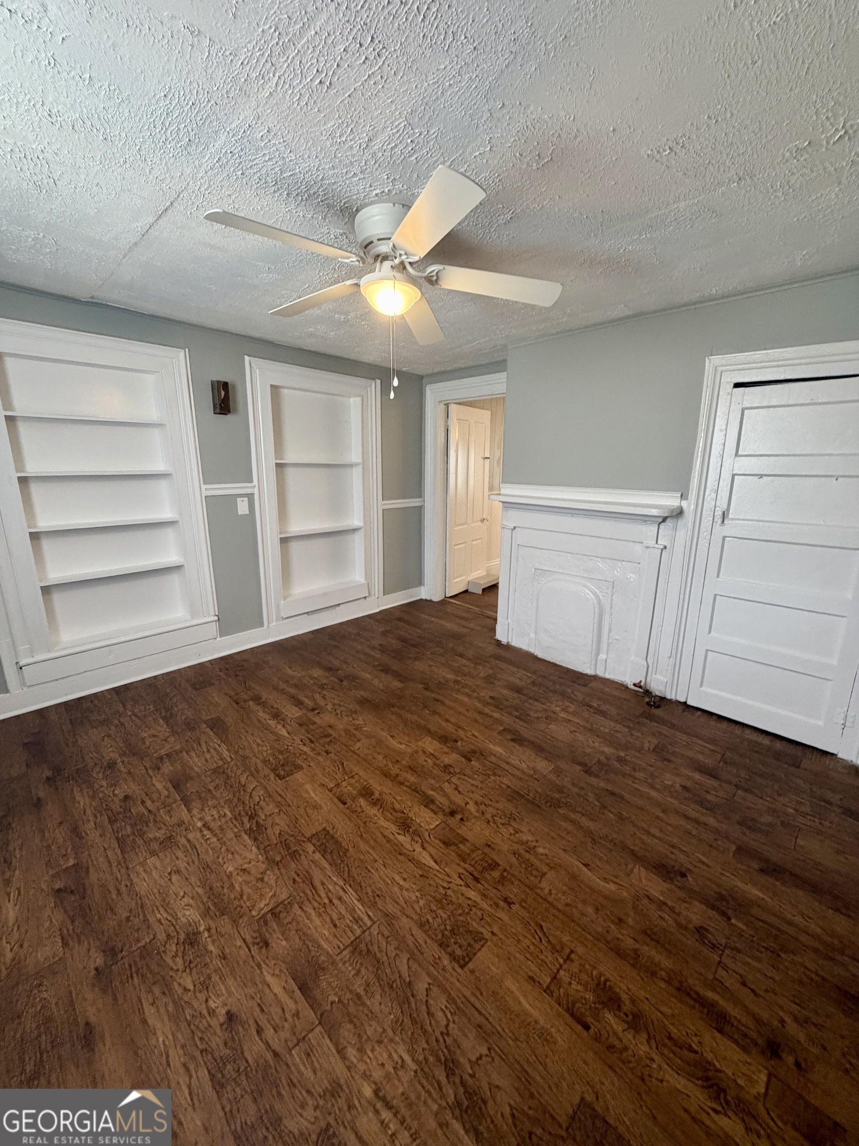 666 Woolfolk Street Macon, GA 31217 - Photo 19 of 60 a view of empty room with wooden floor and fan