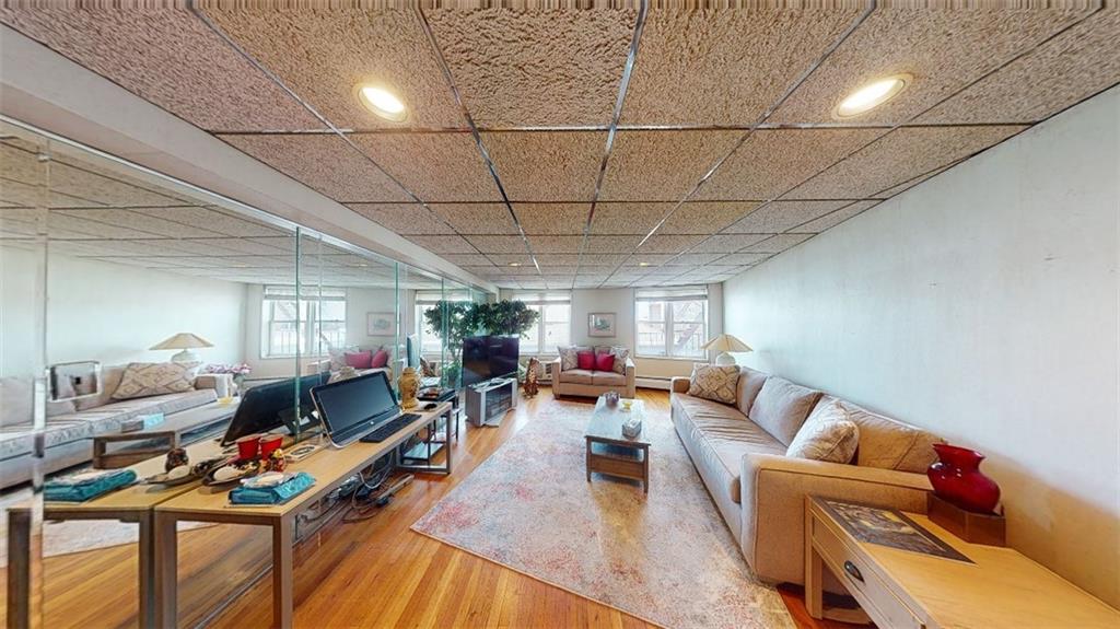 2373 Ocean Parkway, Unit 2J Brooklyn, NY 11223 - Photo 11 of 24 a living room with lots of furniture and a wooden floor