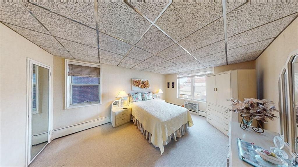 2373 Ocean Parkway, Unit 2J Brooklyn, NY 11223 - Photo 18 of 24 a spacious bedroom with a bed and a chandelier