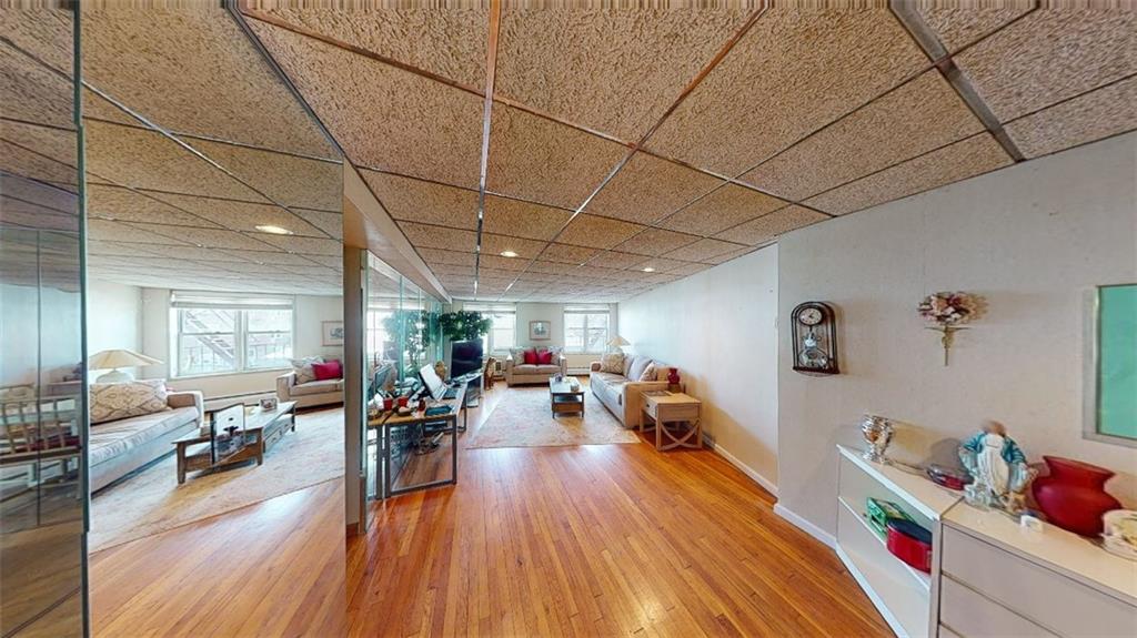 2373 Ocean Parkway, Unit 2J Brooklyn, NY 11223 - Photo 10 of 24 a living room with furniture and a wooden floor