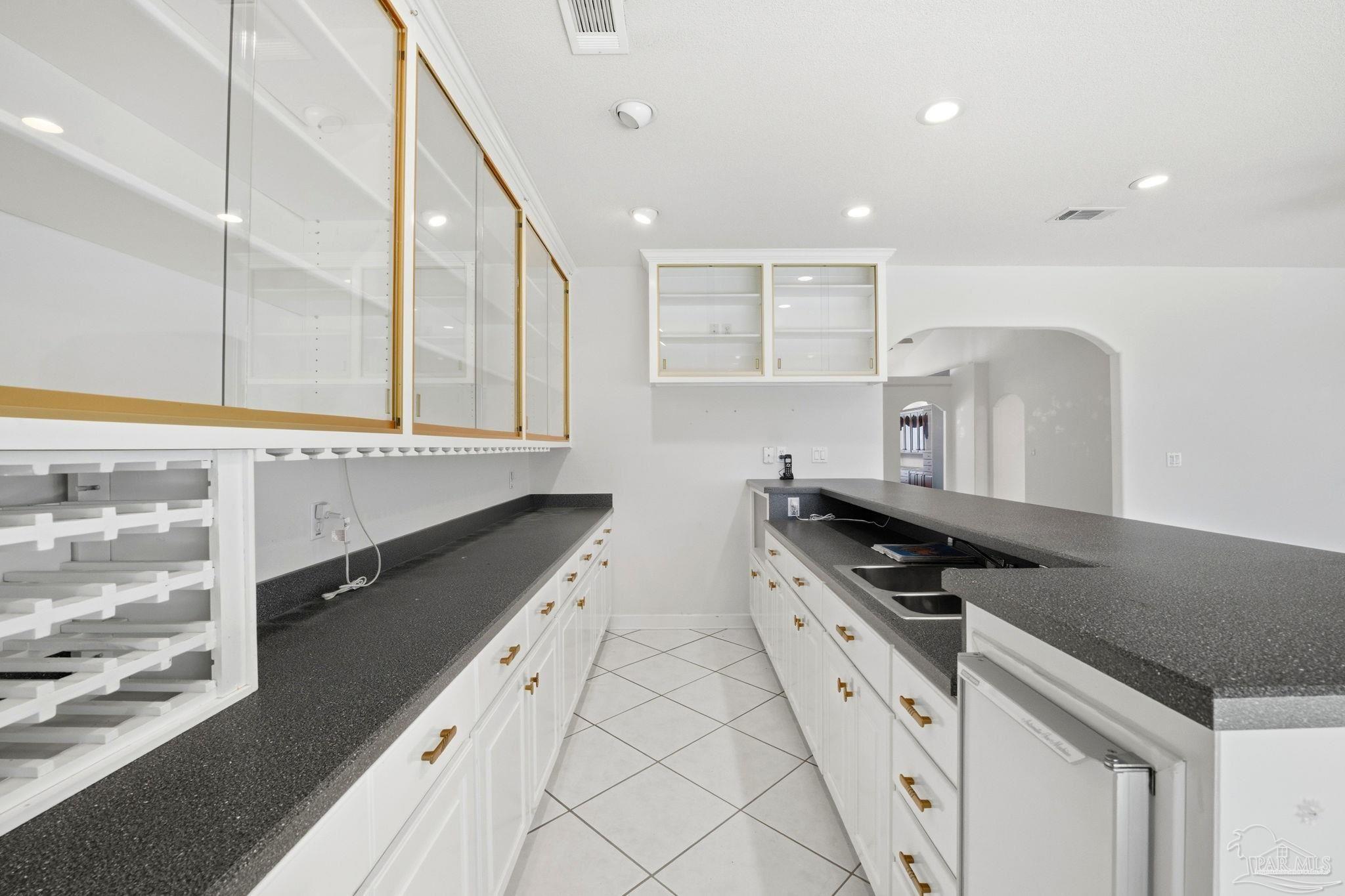 4552 Peaden Road Pace, FL 32571 - Photo 19 of 38 a kitchen with stainless steel appliances a sink and a white cabinets