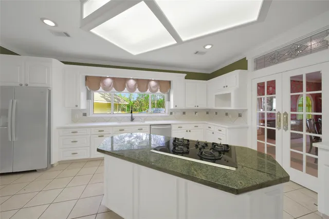 a kitchen with stainless steel appliances granite countertop a sink and a stove