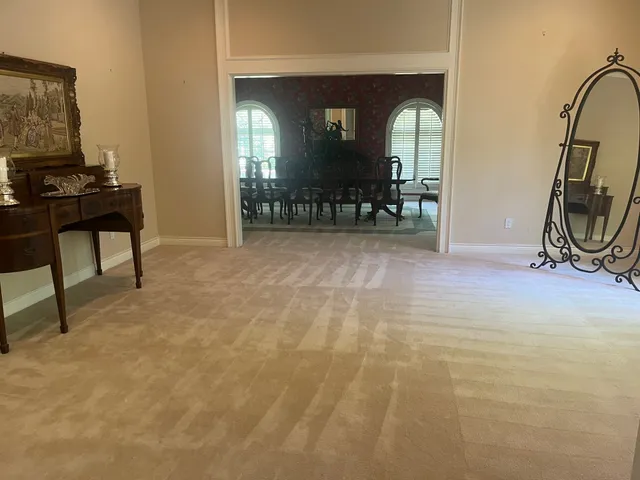 a view of a livingroom with furniture and a mirror